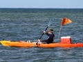 Kayaker supporting a swimmer